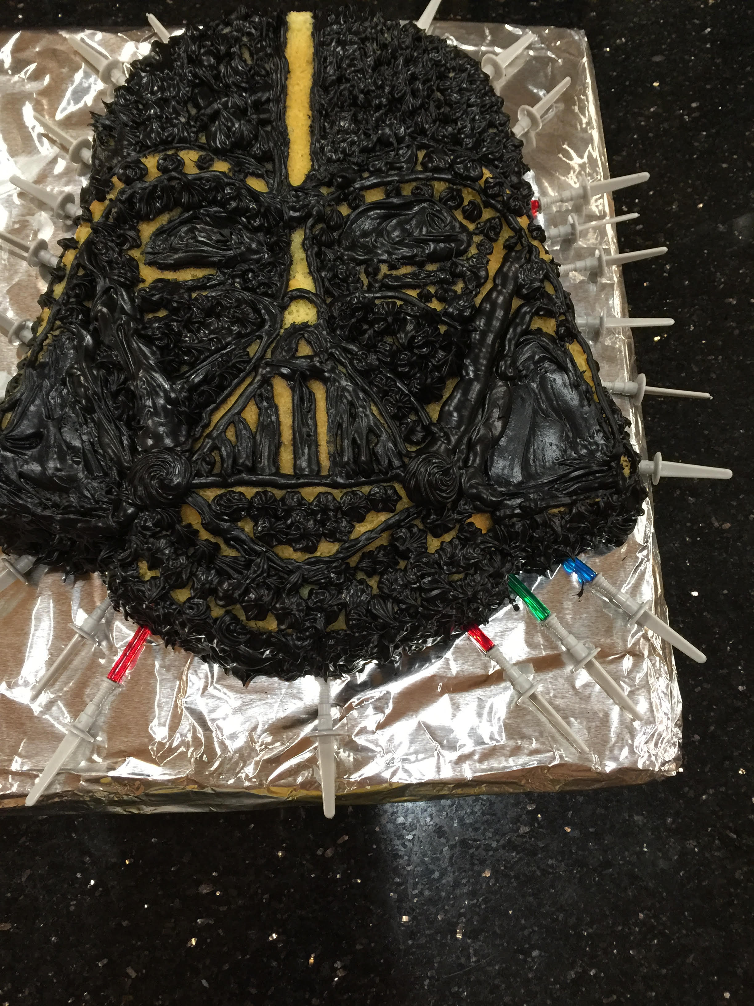 Jacks bday cake Darth Vader with little spears as well as darth vader candles